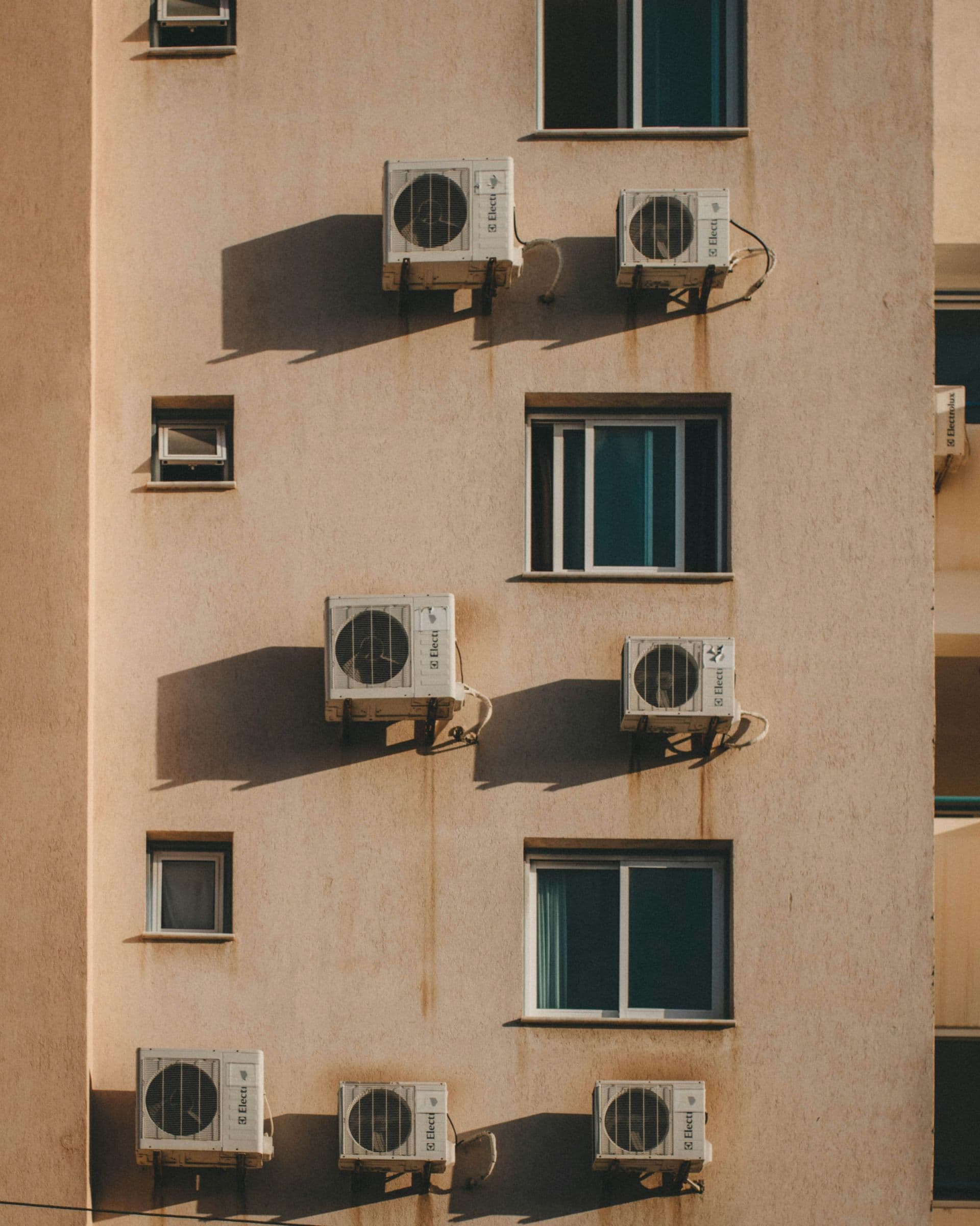 Air conditioning units mounted on building exterior in hot climate